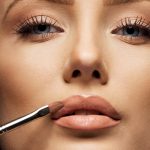 close-up-female-face-with-makeup-lipstick-brush-young-woman-applying-lip-gloss-with-make-up-brush-on-lips-tight-crop_BpbUHNUNtx-1