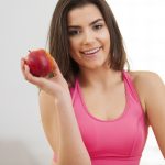 Close up of fitness woman with apple