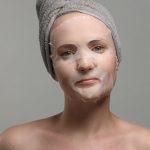 woman with a facial sheet mask on